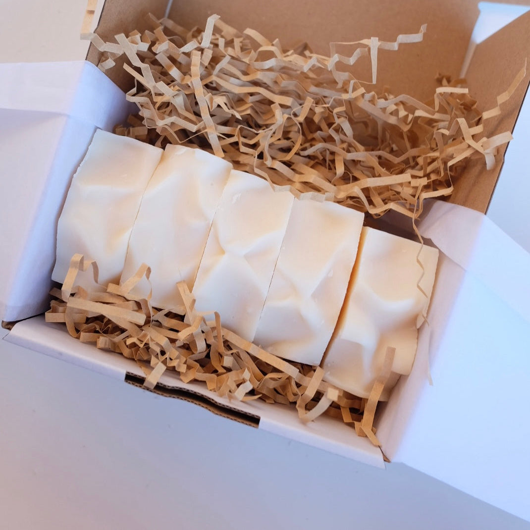 Box of white tallow bars of soap with brown paper inside